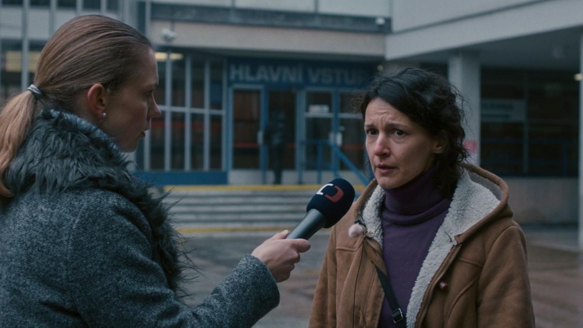 woman news reporter interviewing woman outside