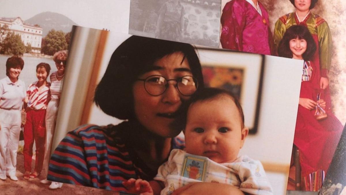 photo of woman holding baby