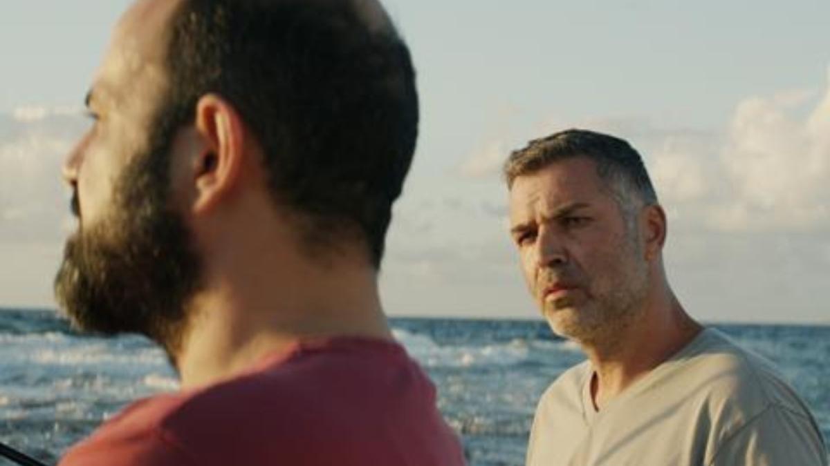 two men standing near water