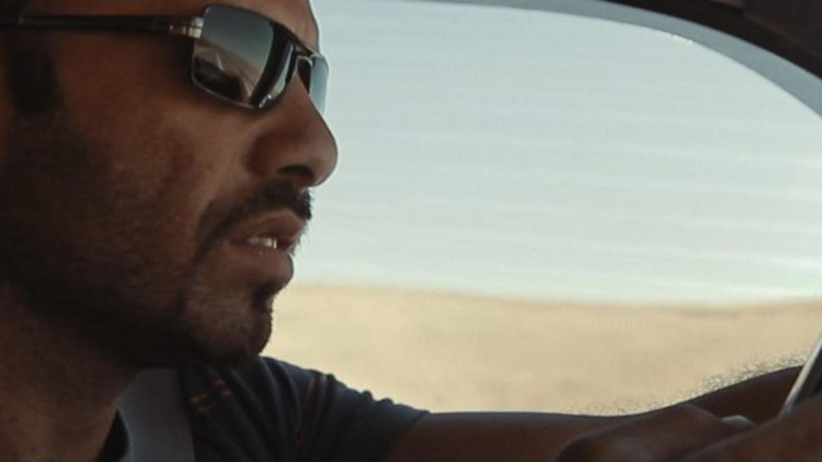 man wearing sunglasses and driving car