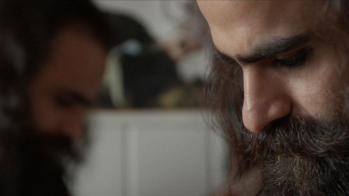 close up of man looking toward ground