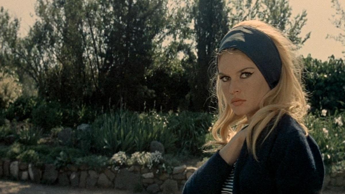 blonde woman wearing headband outside with head turned