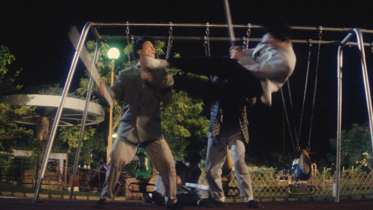 men fighting at night in park