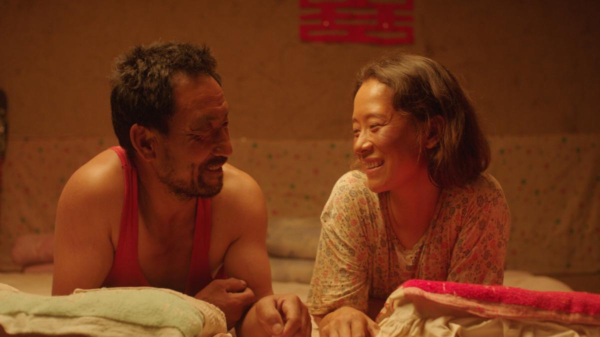 man and woman laying on floor smiling at each other