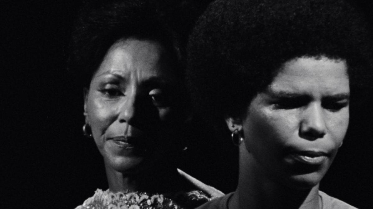 black and white image of two women's faces up close