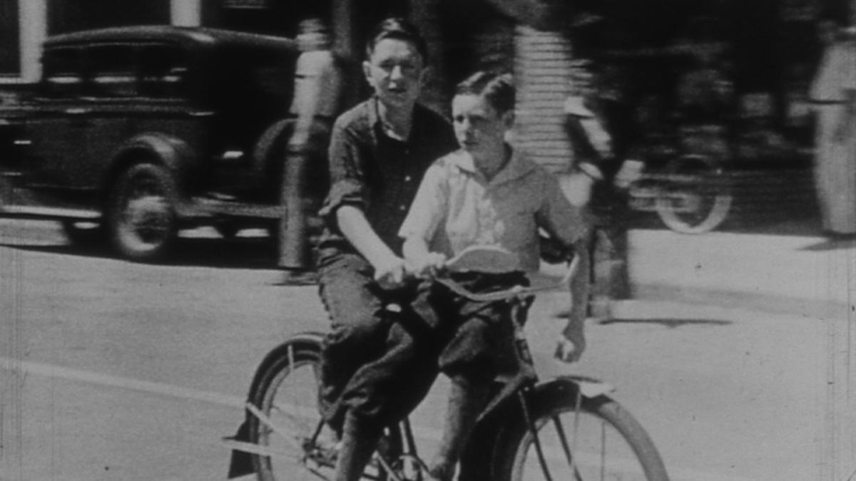 two boys riding on bike