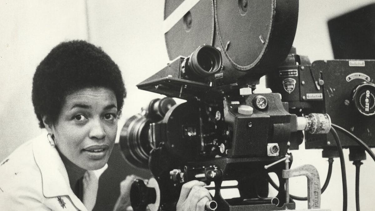 woman kneeling down next to camera