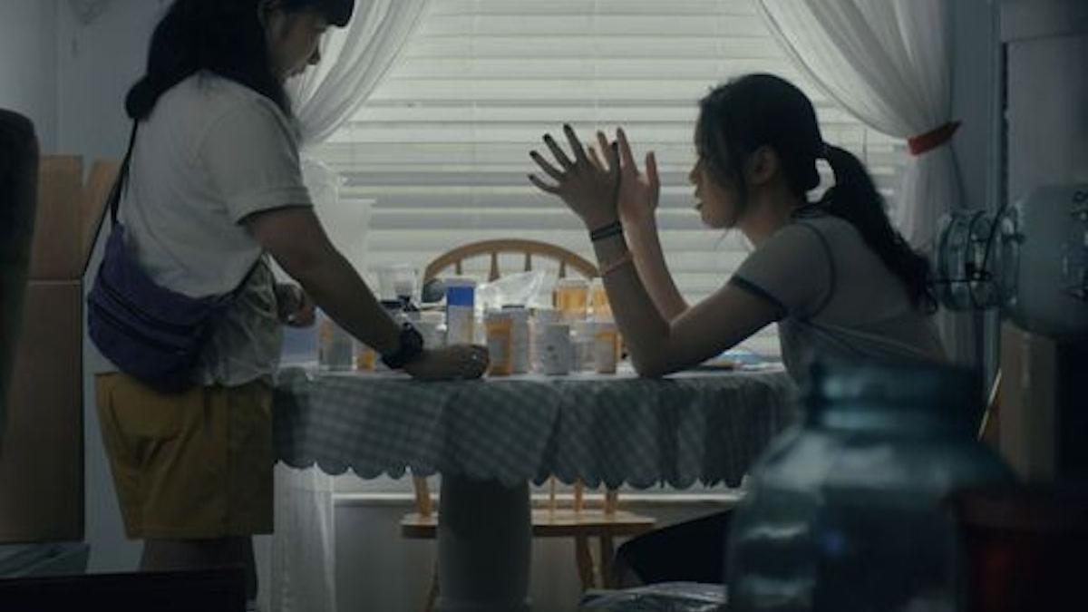 two girls sitting at kitchen table