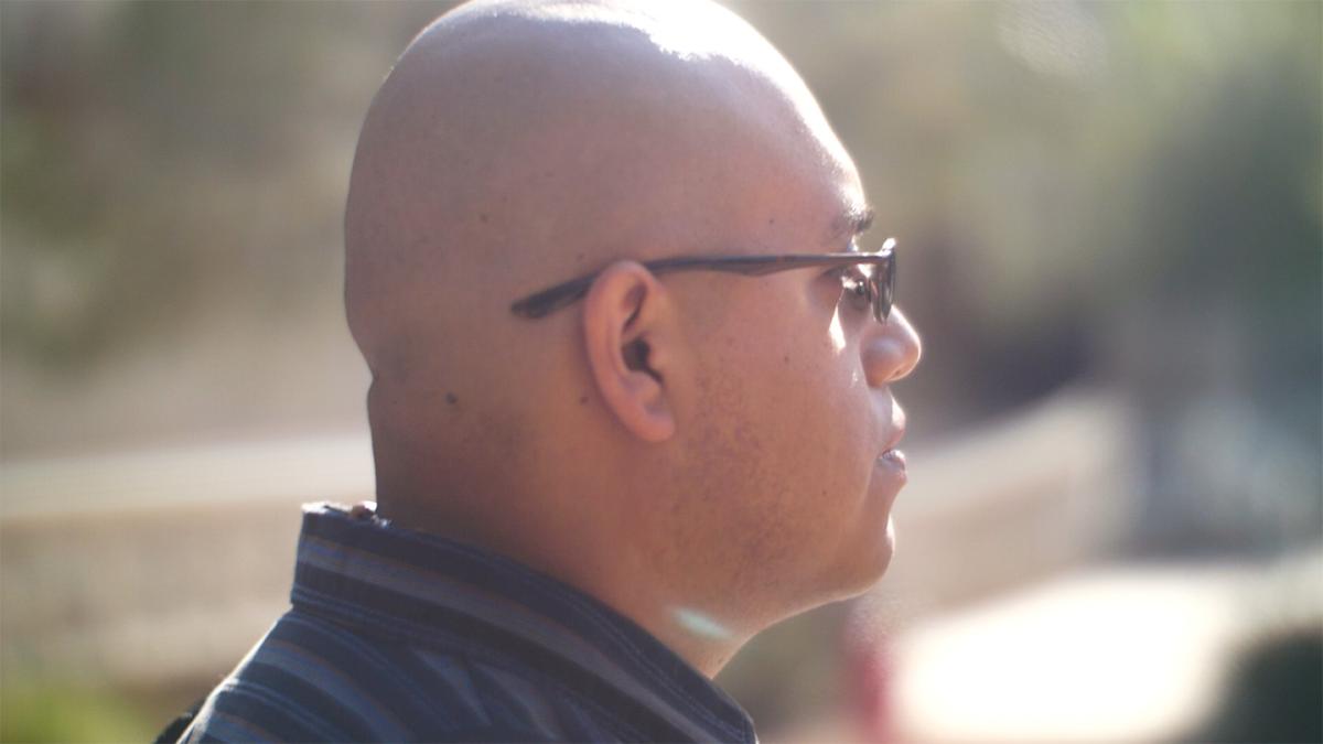 side profile of bald man wearing glasses