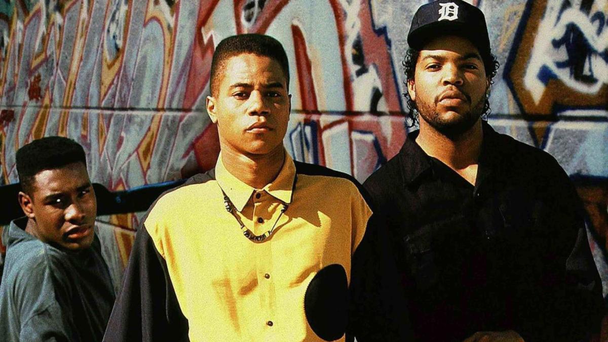three boys standing in front of graffiti wall