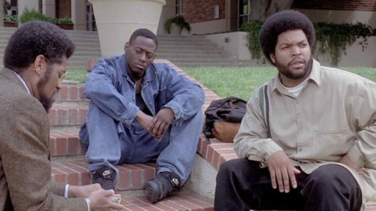 four people looking down hallway pictured from below