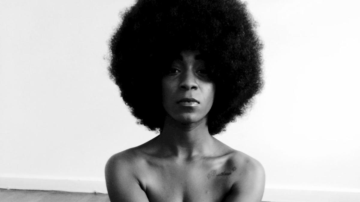 woman with afro and bound arms and legs