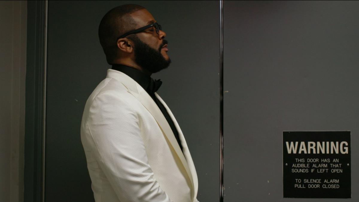 man in white sport jacket looking to distance