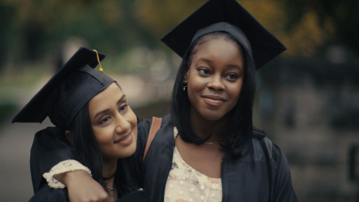 two girls in graduation caps and gowns