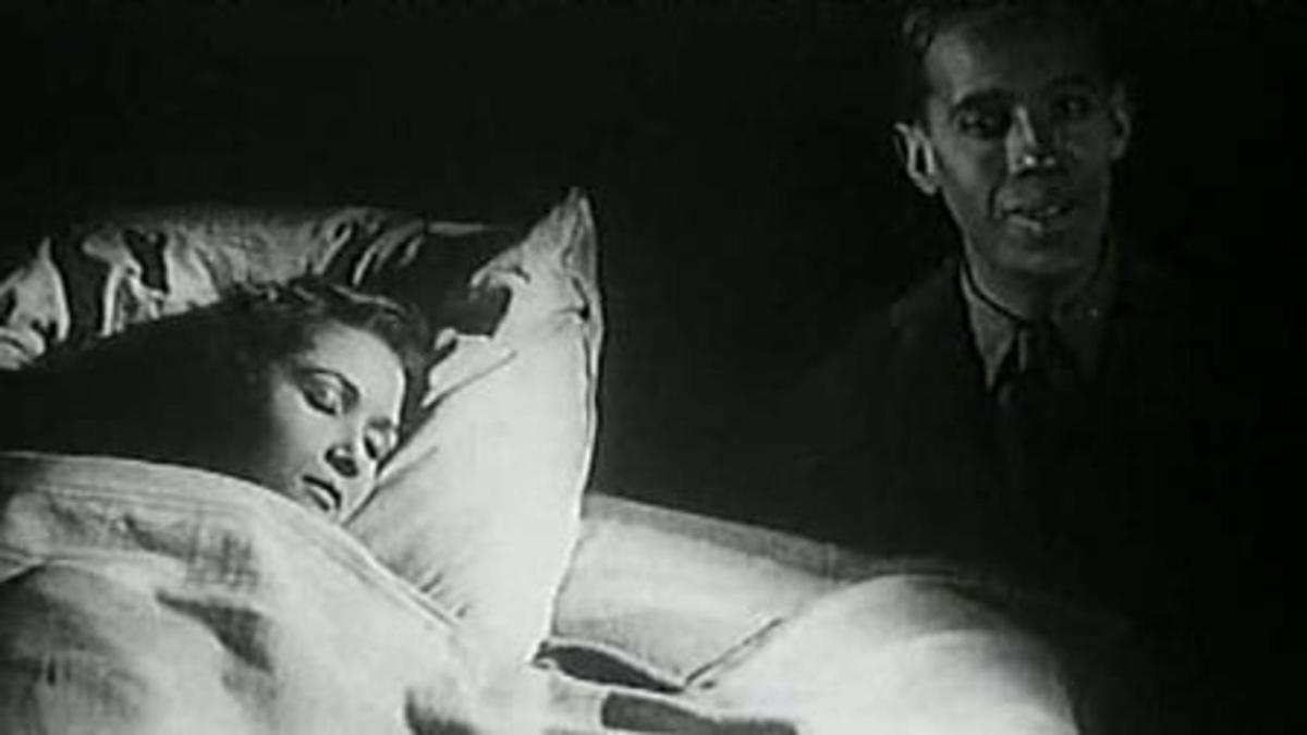 black and white image of woman sleeping in bed