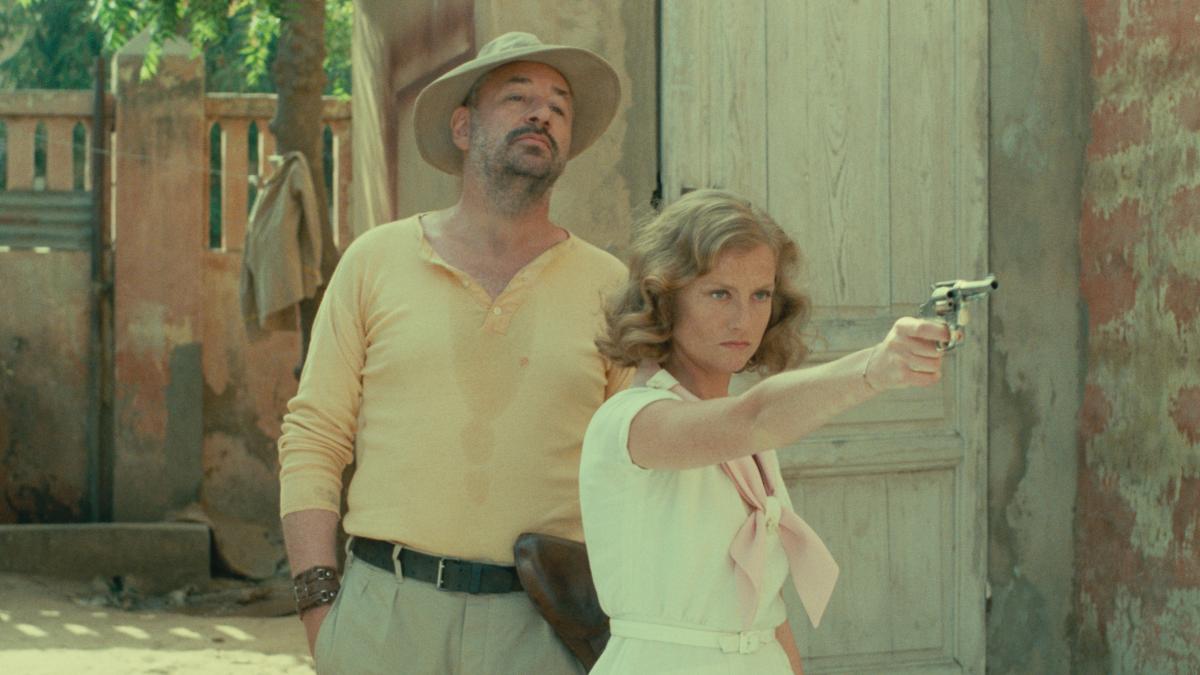 man and woman standing outside with woman holding gun