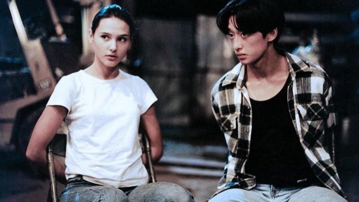 young woman and man with arms tied behind backs to chairs