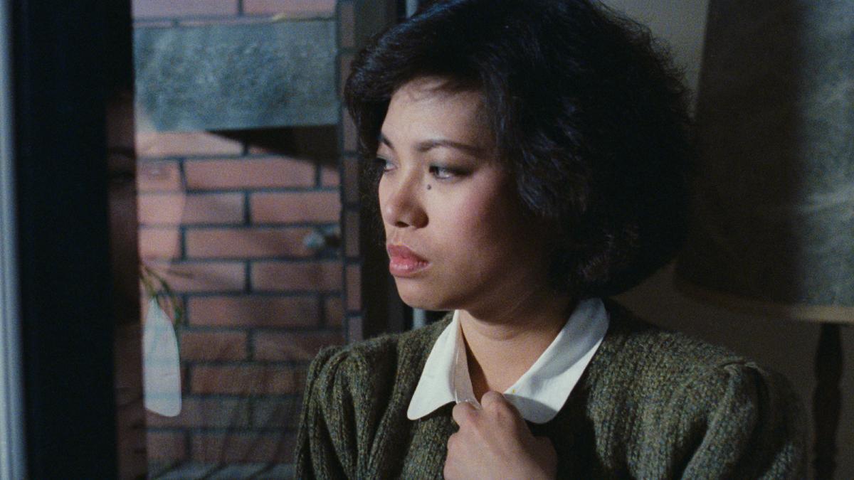 woman clutching shirt looking into distance