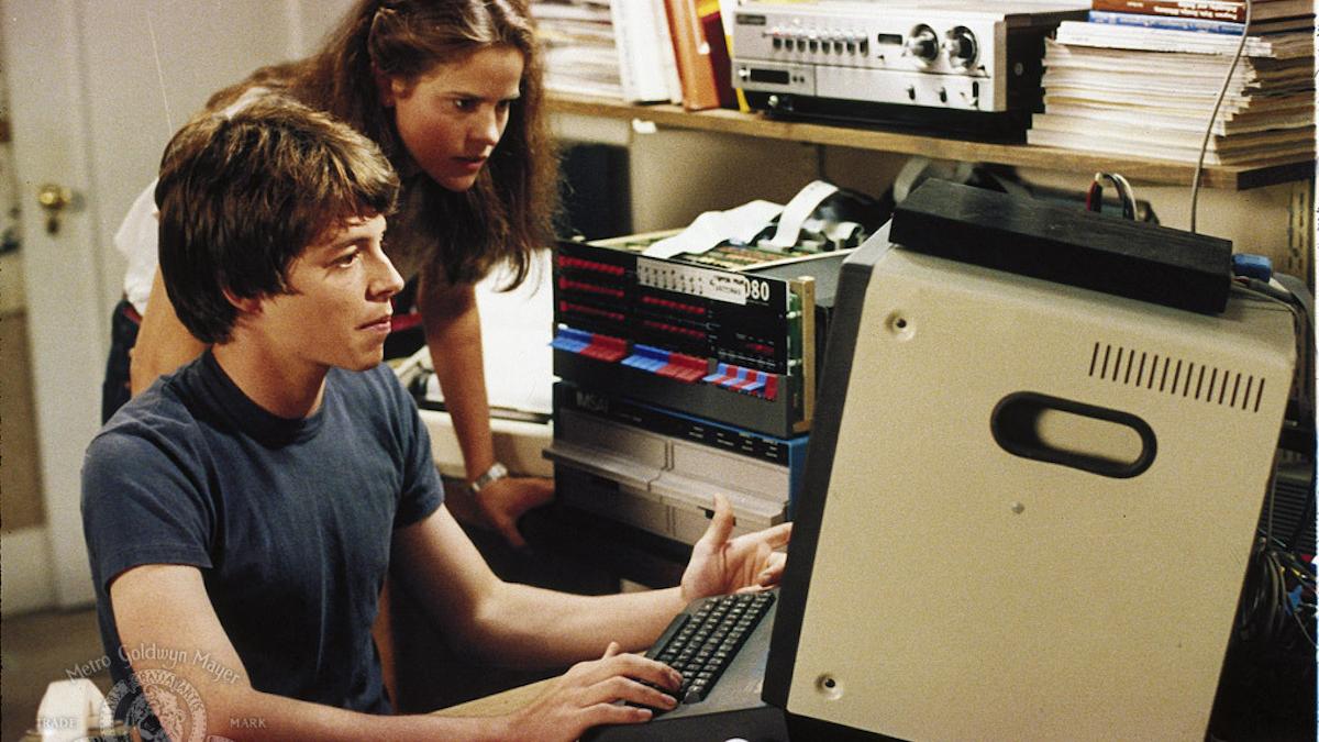 man and woman looking at computer screen