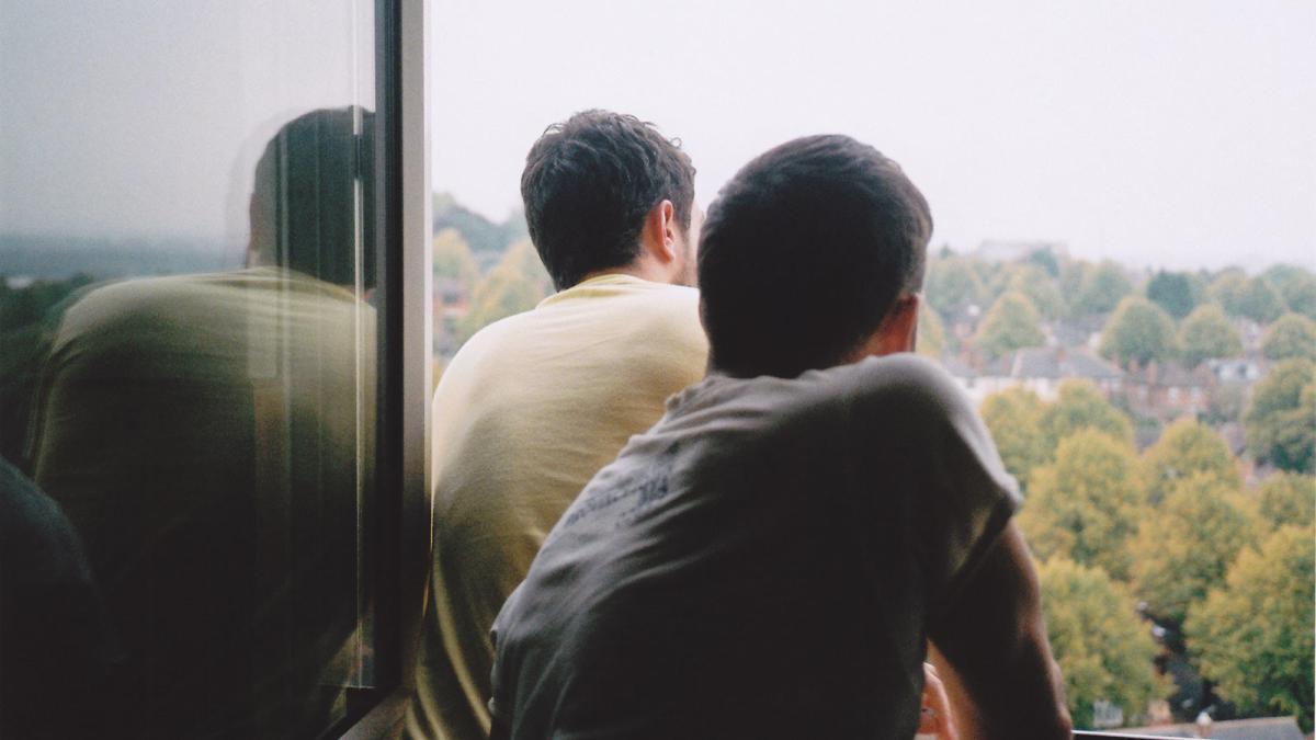 two men looking out window