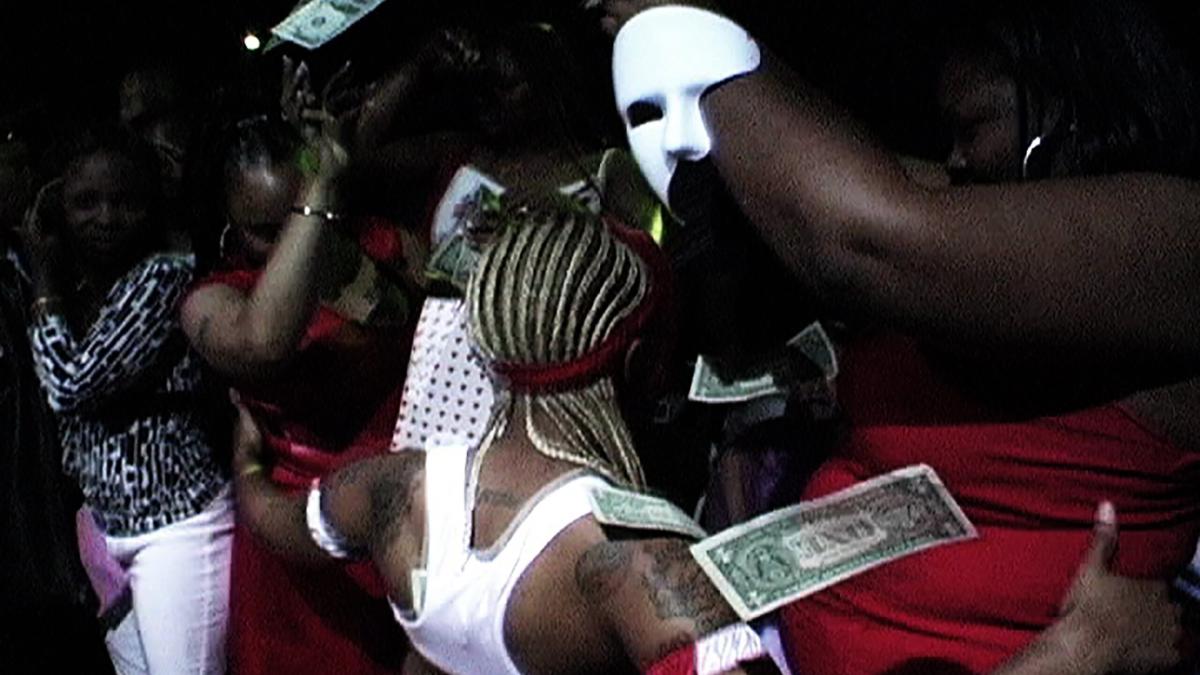 aerieal shot of several people gathered around with cash