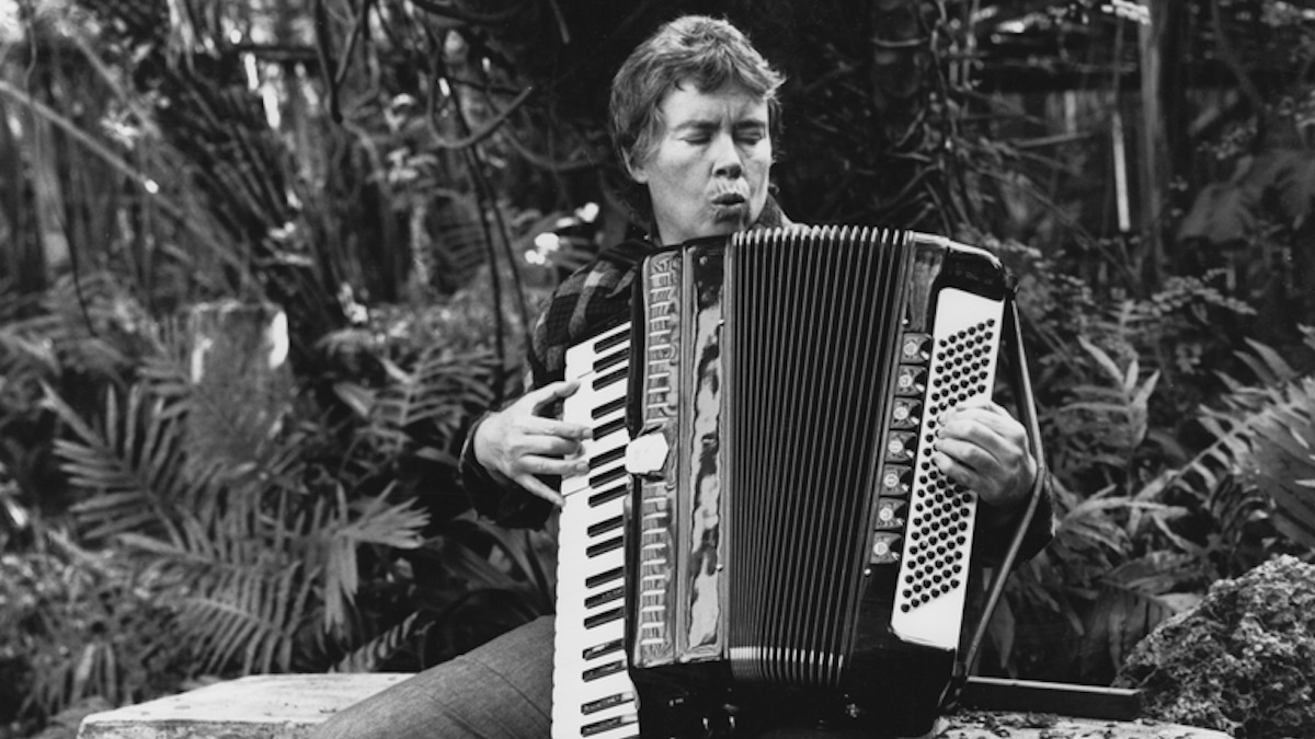black and white photo of person playing accordion