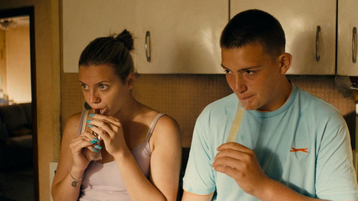 couple sitting on counter sipping drinks out of straws