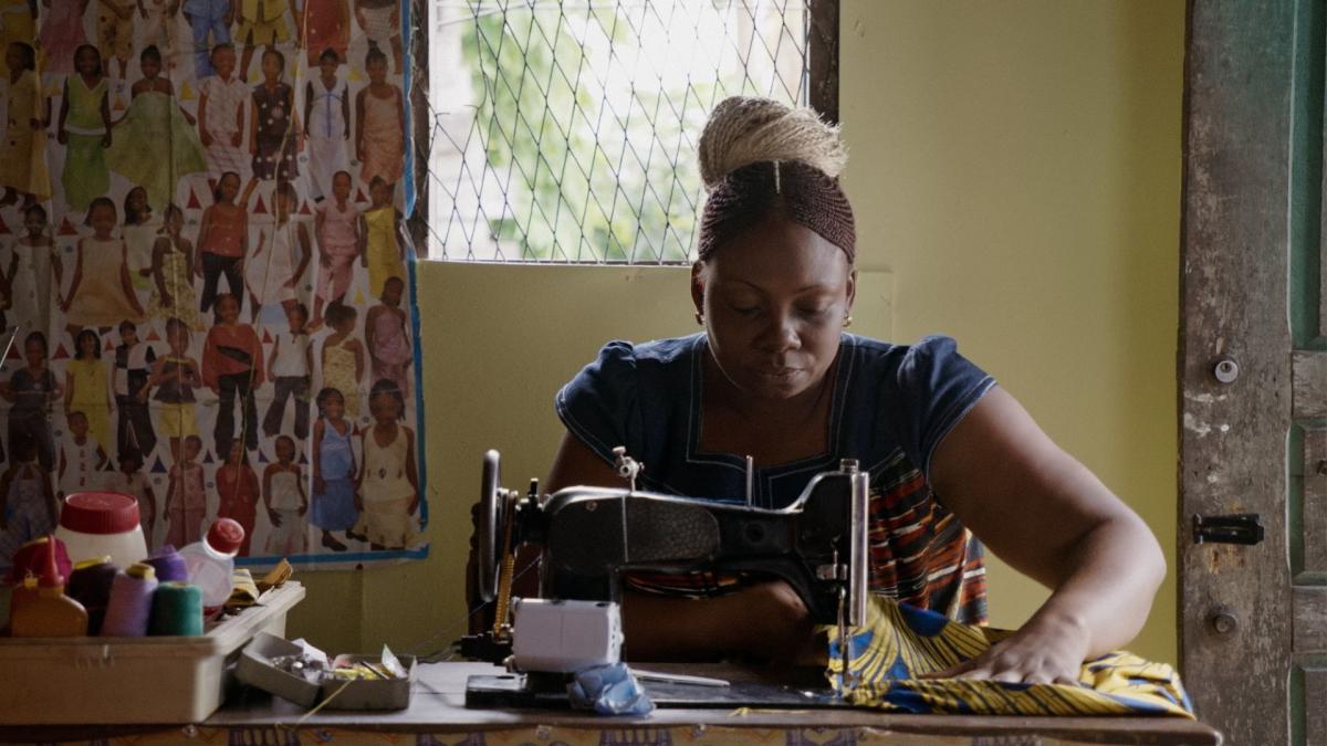 Black woman with bun working at sewing machine