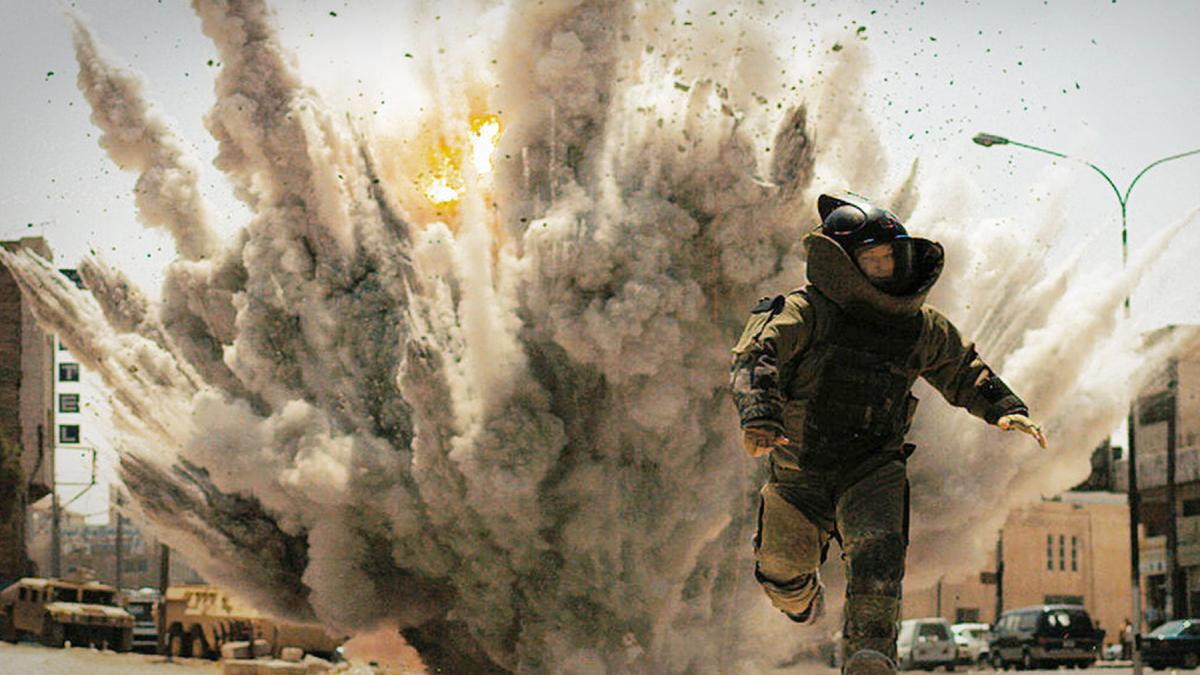 man in battle running from explosion