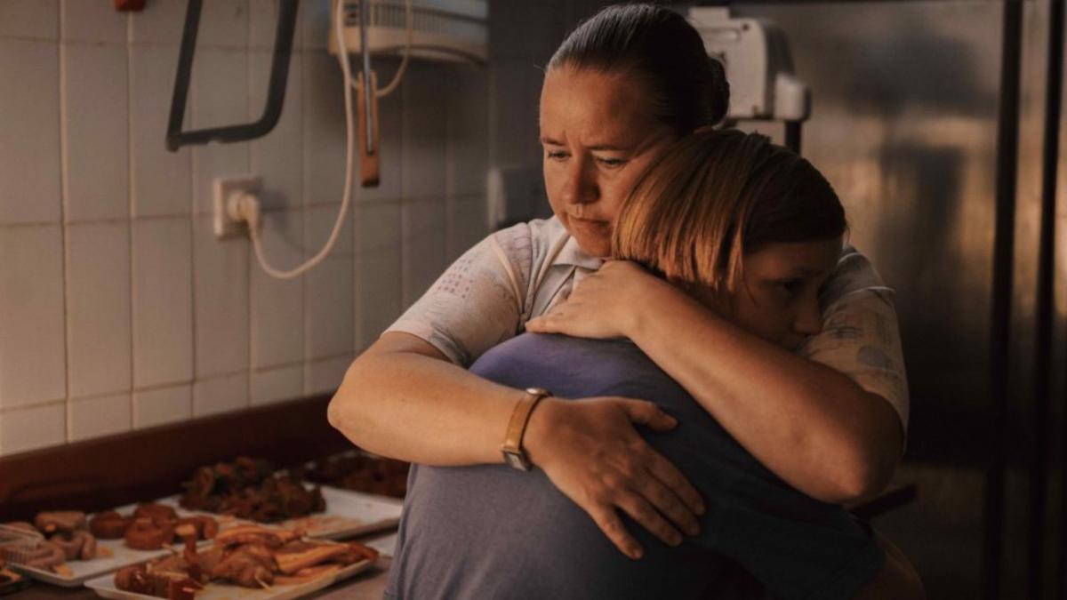 man hugging woman in kitchen