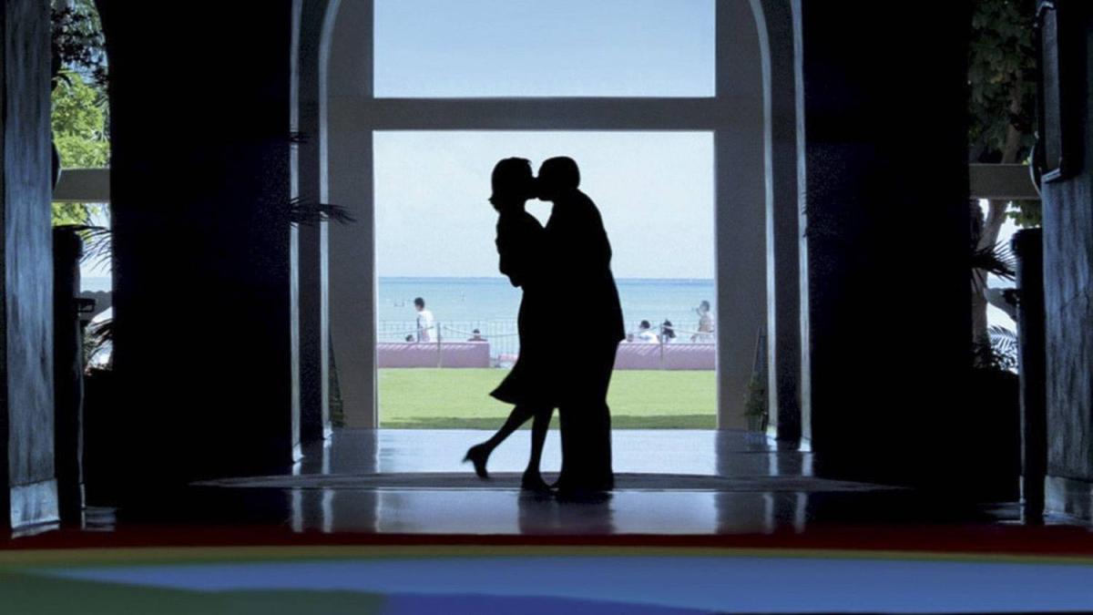 couple kissing in door frame