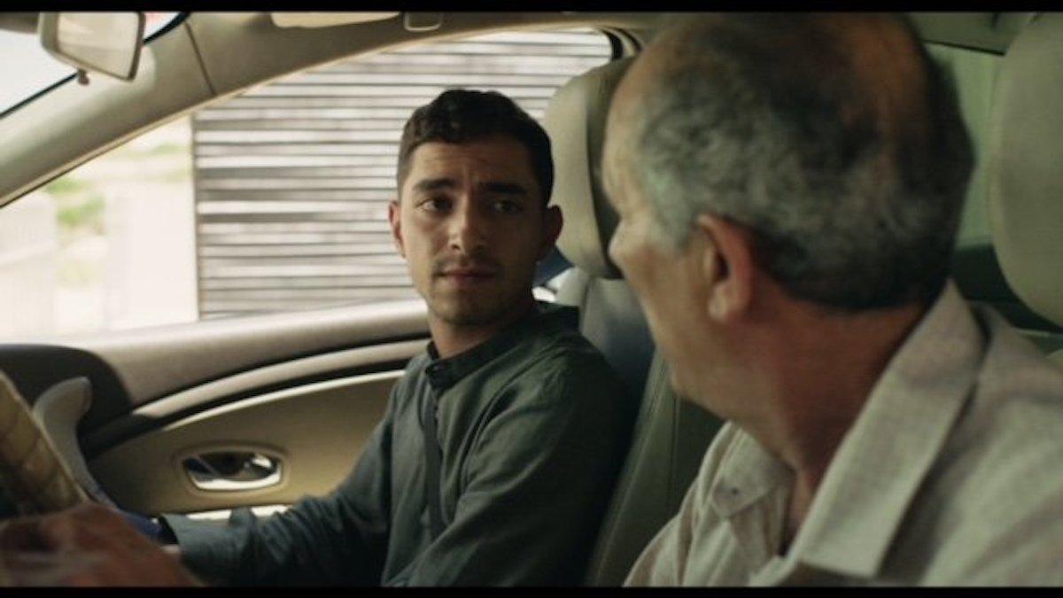 two men sitting in car