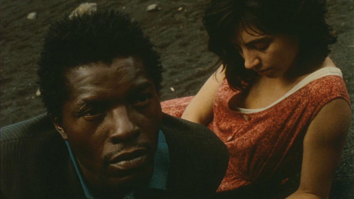 man and woman lying near each other on the grass