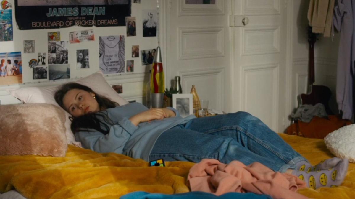 woman lying on bed looking off into distance