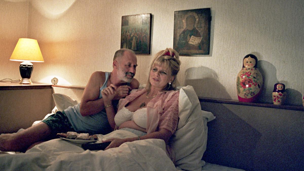 man and woman lying in bed together