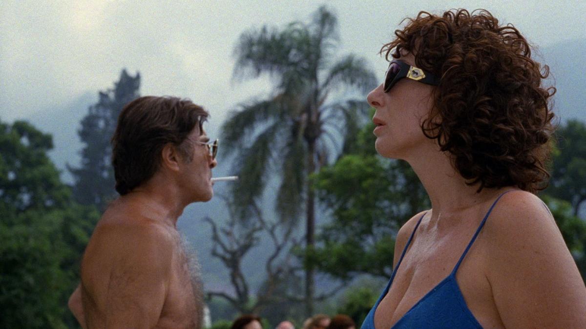 couple standing on beach looking outwardly