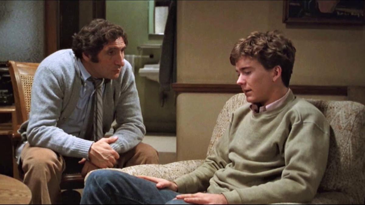 man and boy sitting in living room and talking