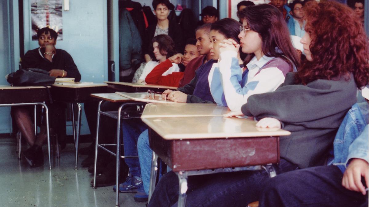 students sitting at desks in high school classroom