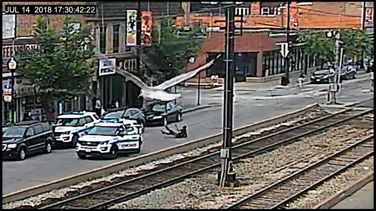 surveillance footage of traffic intersection with police car