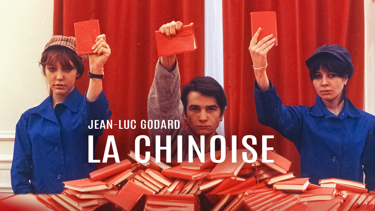 LA CHINOISE, 1967, Jean Luc Godard two women in blue coats and man in grey coat all holding up red books in front of red background