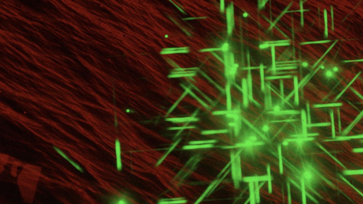 Red geometric background with green geometric lights overlaid