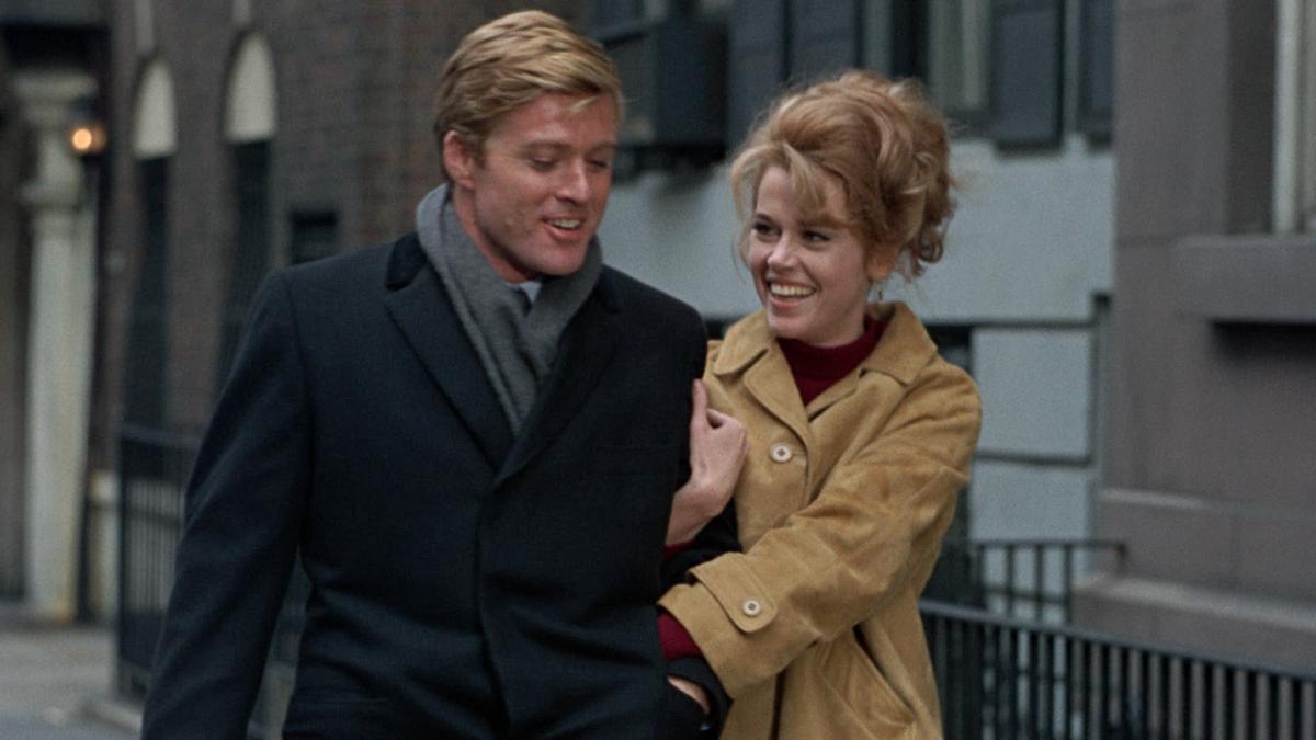 BAREFOOT IN THE PARK, 1967, man and woman walking arm and arm down street with fall jackets