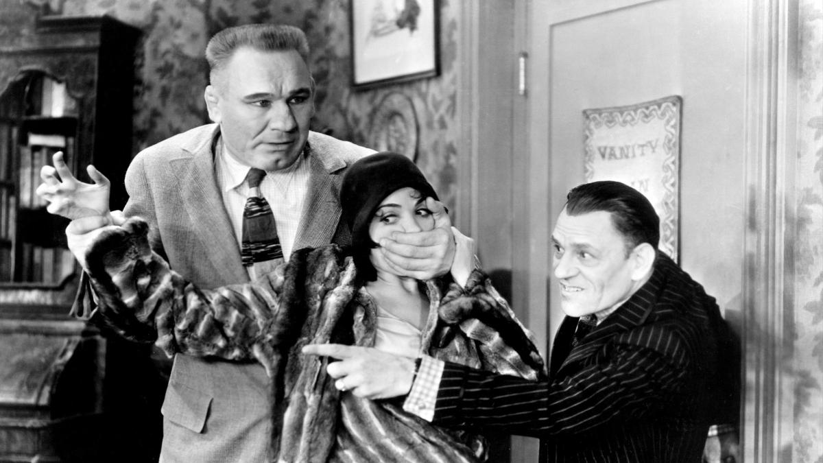 THE UNHOLY THREE, 1930, two men in suits holding a woman's mouth shut with guns in hand