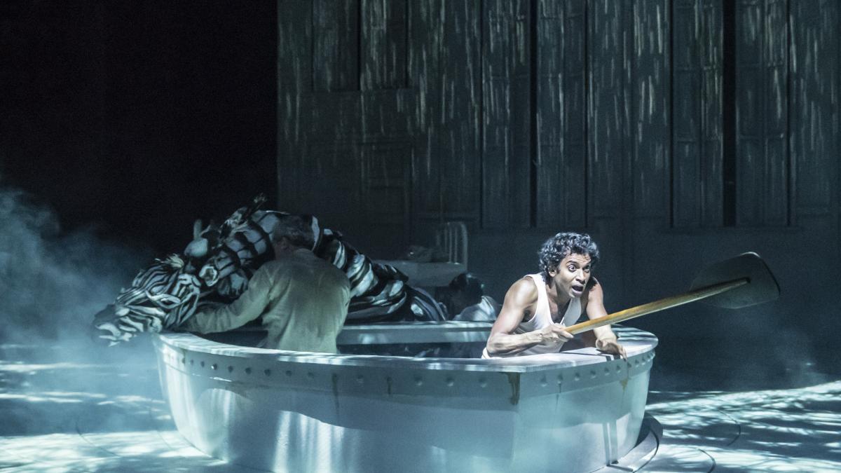 young man sitting in boat leaning over the side