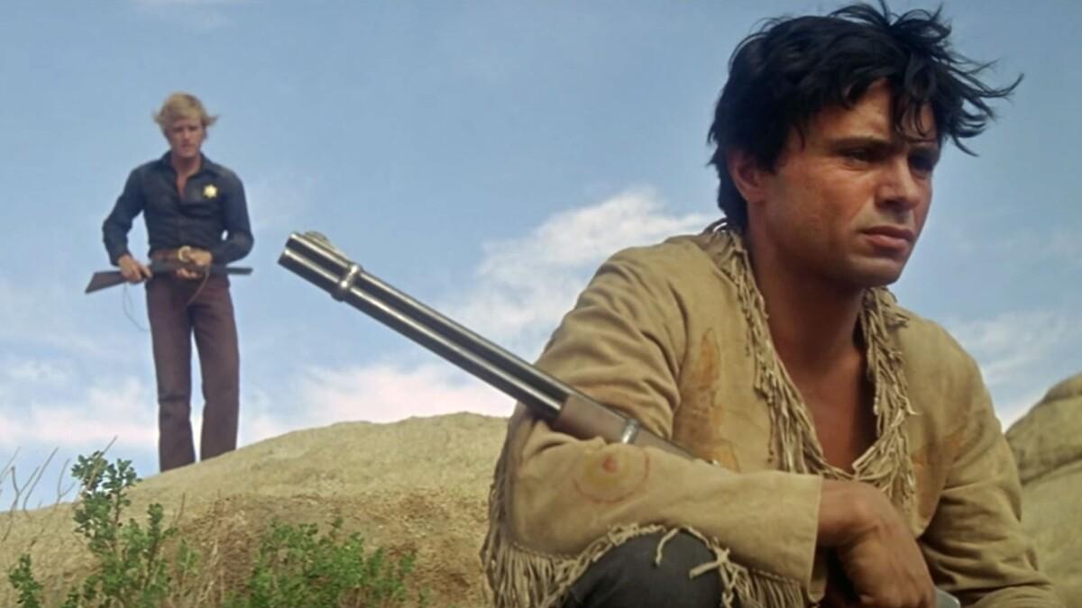 TELL THEM WILLIE BOY IS HERE, 1969, man holding gun hunched over with another man holding gun walking up behind him