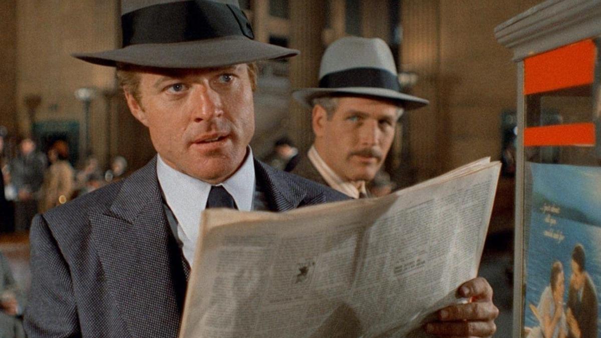 THE STING, 1973, man in suit and hat holding newspaper looking ahead