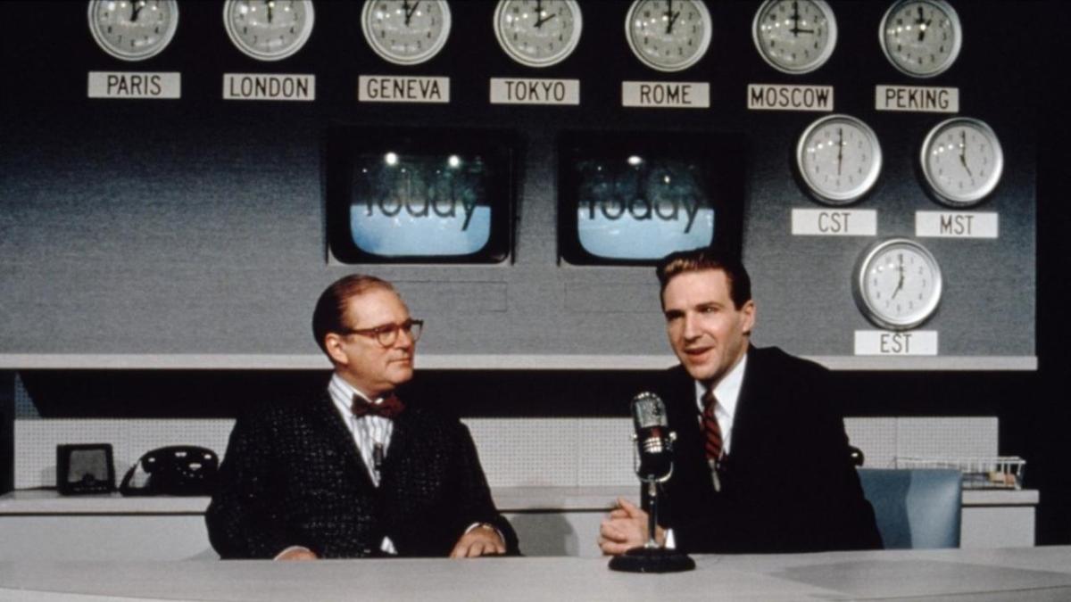 QUIZ SHOW, 1994, two men seated at broadcast table in front of microphone