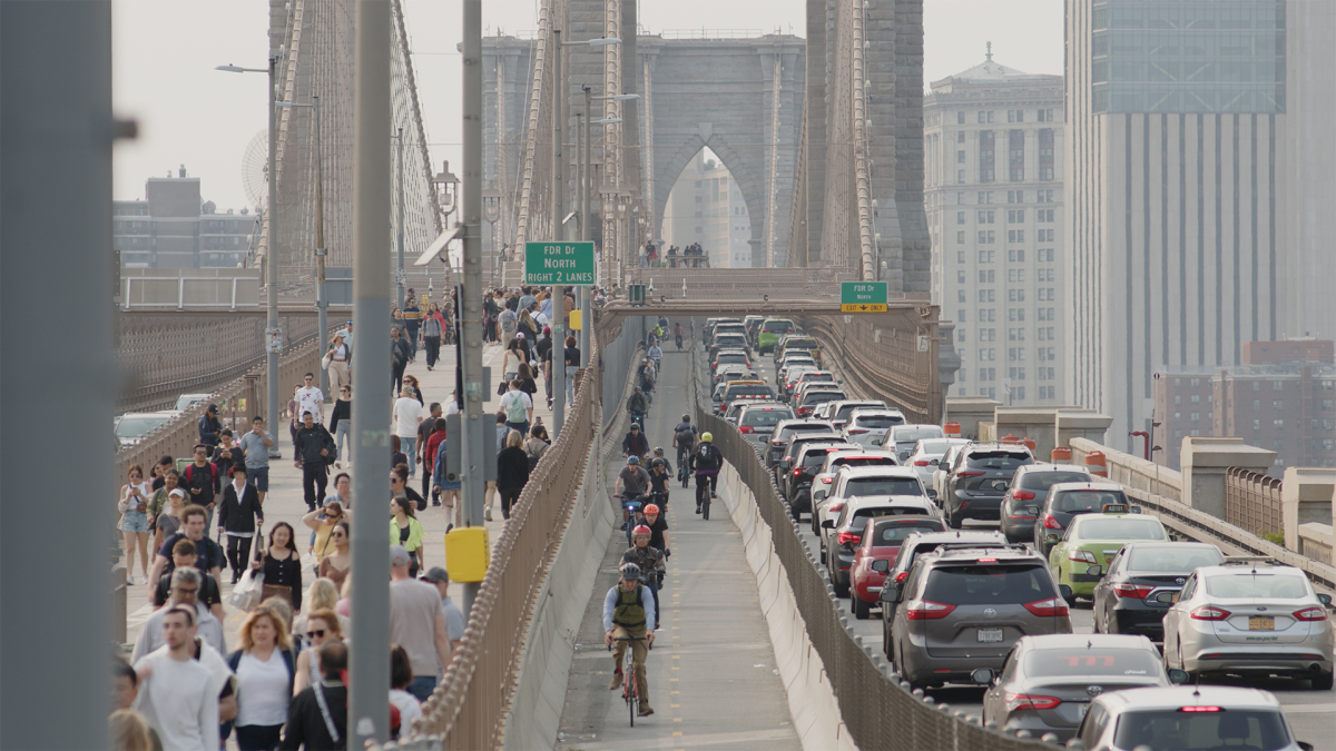 CHANGING LANES, 2025, high shot of cars, bikers, and pedestrians on the Brooklyn Bridge