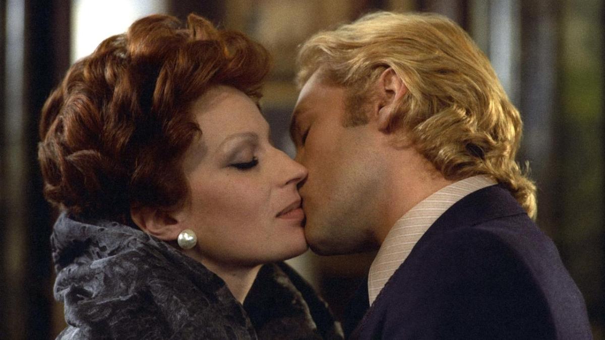 CONVERSATION PIECE, 1974, close up of man kissing the side of woman's mouth