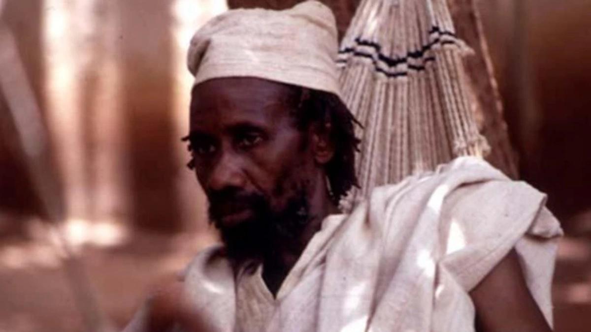 KEÏTA: THE HERITAGE OF THE GRIOT, 1995, Black man in white hat and shirt looking off into distance